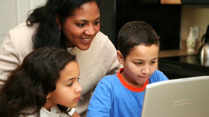 mom helping kids with computer